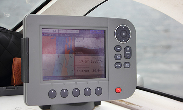 Marine chartplotter displaying navigation data on a yacht.