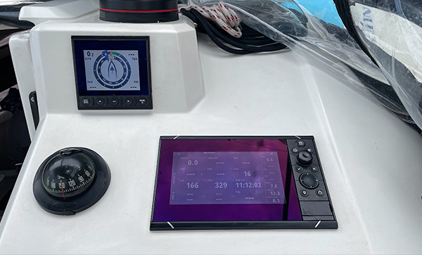 Navigation system display with chartplotter, compass, and instrumentation on a yacht.