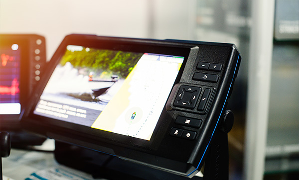 Chartplotter displaying GPS navigation data and map, part of marine electronics installation.